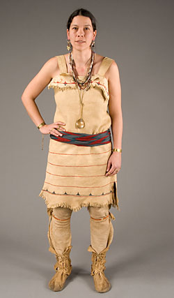 model wearing deerskin dress, leather leggings, and moccasins