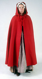 model wearing bright red wool cape with large hood
