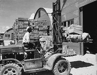 file:/activities/oralhistory/cappics/elliot1939s_forklift, alt: an african-american soldier operating a forklift